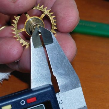 Using a micrometer to check pivot
