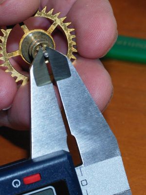 Using a micrometer to check pivot