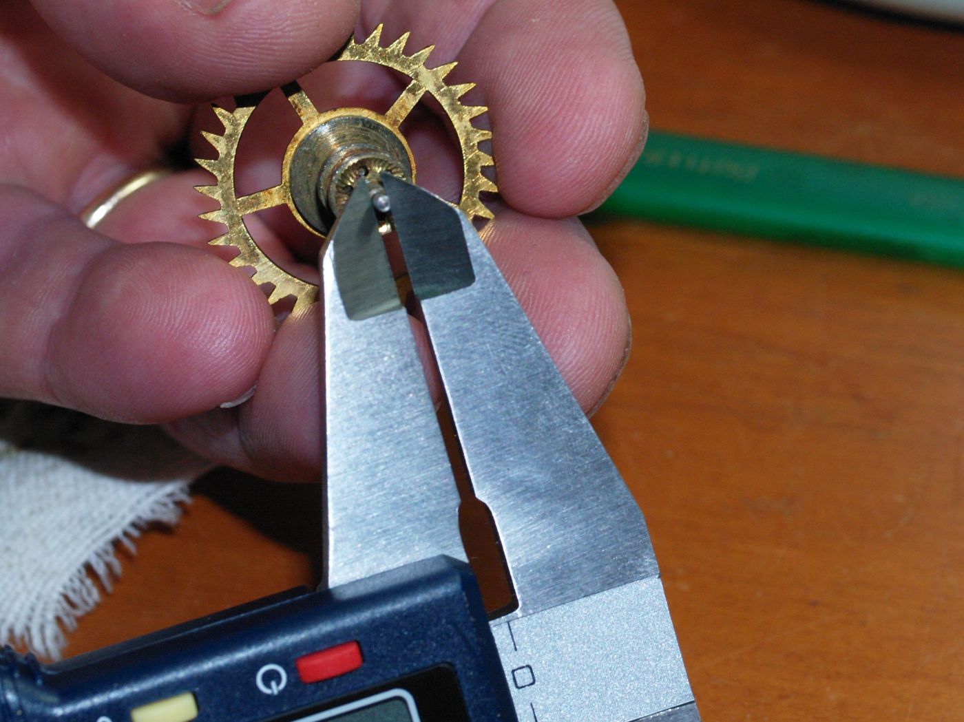 Using a micrometer to check pivot