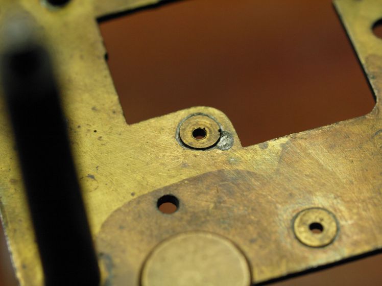 Punch mark adjacent to bushing