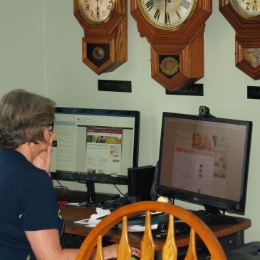 Trio of clocks above computer