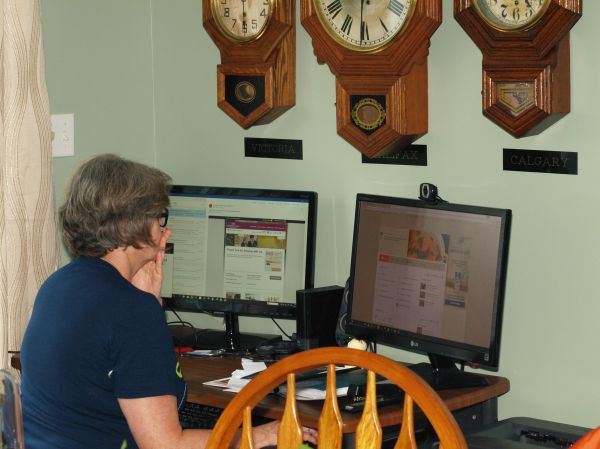Trio of clocks above computer
