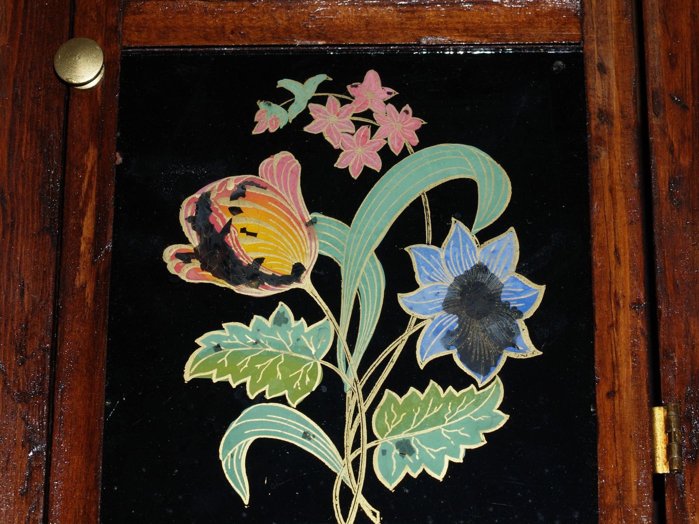 Lower tablet shiowing reverse paintiung of flowers