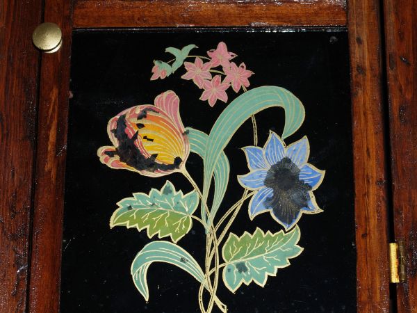 Lower tablet shiowing reverse paintiung of flowers