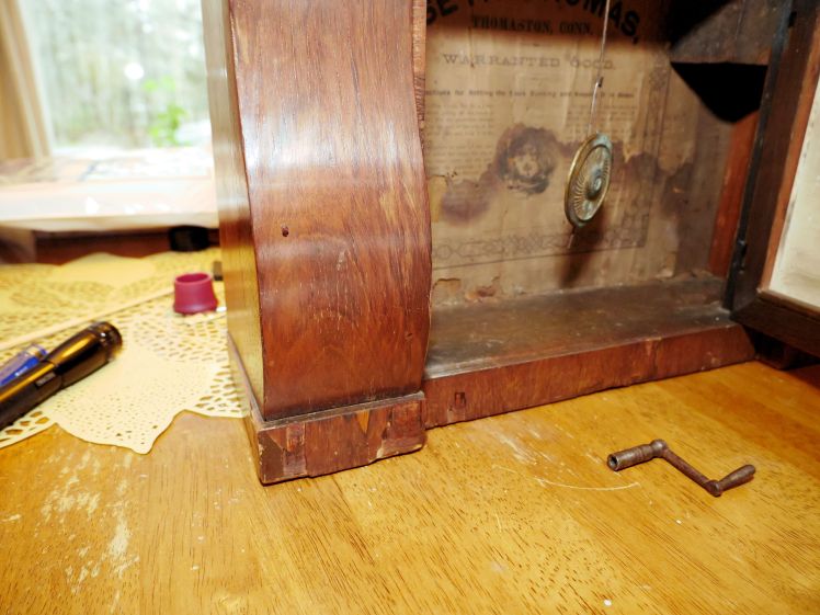 Chipped veneer below sleigh foot