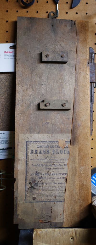 Ansonia backboard with partial label and a piece of backboard glued to an original piece of backboard