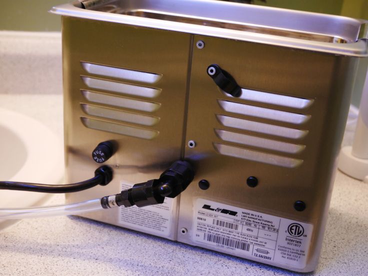 Back of unit showing fuse, drain hose and clip for plastic hose