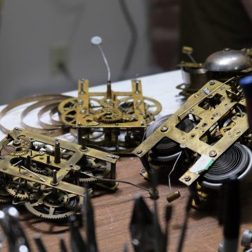A collection of clock movements in need of repair