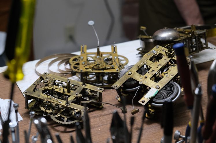 A collection of clock movements in need of repair
