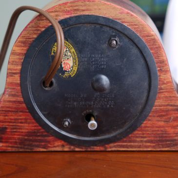 Back of clock showing patent dates, CSA decal, adjustment knob and cord