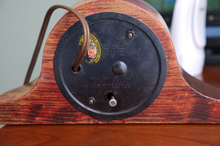 Back of clock showing patent dates, CSA decal, adjustment knob and cord