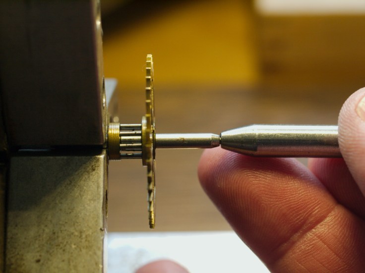 Using a hollow end punch to straighten a pivot