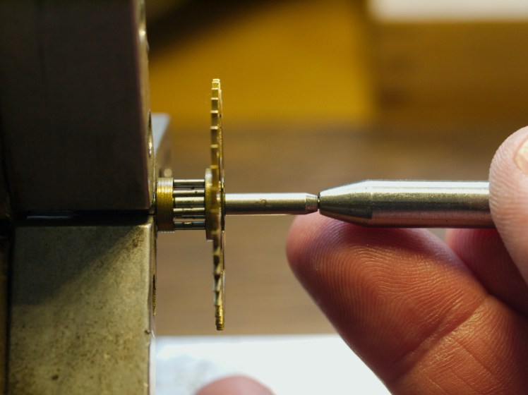 Using a hollow end punch to straighten a pivot