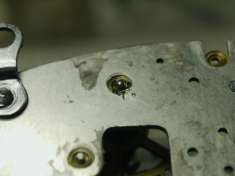 Punch marks around a pivot hole