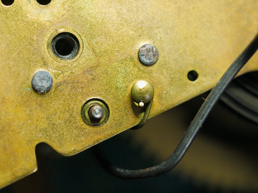 Brass helper spring hooked around a post of a type 89 movement